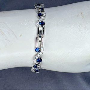 silver tone bracelet | blue & white zirconia stones | infinity style design.